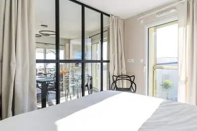 a bedroom with a bed and a dining room at SPLENDIDE APPARTEMENT NICE BLUE PEARL TOUT CONFORT VUE MER PANORAMIQUE in Nice
