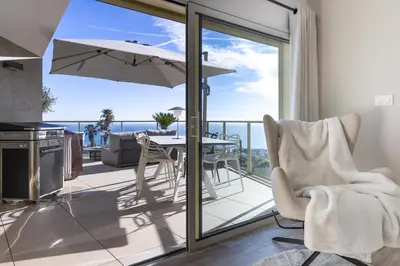 a kitchen and dining room with a view of the ocean at SPLENDIDE APPARTEMENT NICE BLUE PEARL TOUT CONFORT VUE MER PANORAMIQUE in Nice