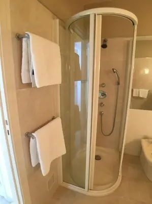 a bathroom with a shower with towels and a sink at Appartement „Bellevue“ Villefranche-sur-Mer in Villefranche-sur-Mer