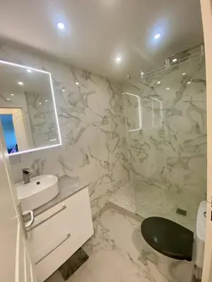 a white bathroom with a sink and a mirror at Nice Ouest- 2P au Calme, Piscine, AC in Nice
