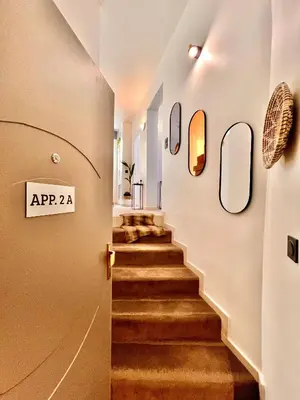 a hallway with stairs with a sign that reads ap at LIBERATION CENTER - PRIVATE Balcony - 24&7 RECEPTION - LUGGAGE STORAGE in Nice
