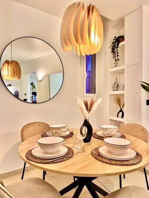 a dining room with a table and a mirror at LIBERATION CENTER - PRIVATE Balcony - 24&7 RECEPTION - LUGGAGE STORAGE in Nice