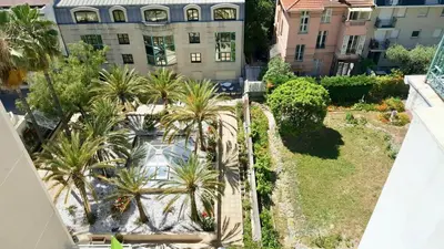 an overhead view of a courtyard with palm trees and a building at SuperbeStudio in Nice - 450m of the sea- garden view in Nice