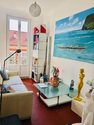 a living room with a couch and a table at APPARTEMENT NICE le PORT in Nice