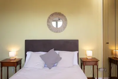 a bedroom with a bed with a mirror and two lamps at L11 Claire Fontaine Sea view 2 BDR AC Parking swiming pool in Nice