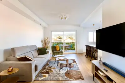 a living room with a couch and a flat screen tv at Appartement Loulib I Electio in Nice