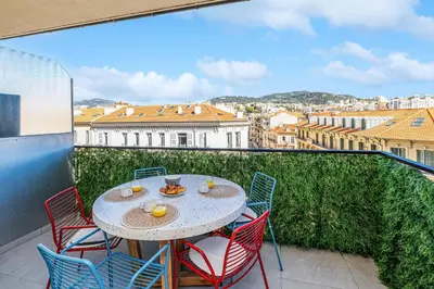 a patio with a table and chairs on a balcony at Appartement Loulib I Electio in Nice