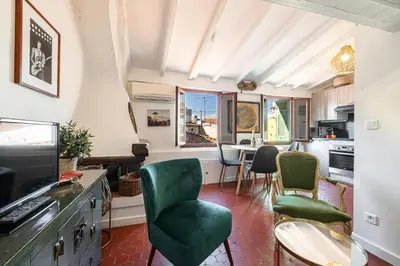 a living room with green chairs and a table at Charming Apartment Old Town in Nice