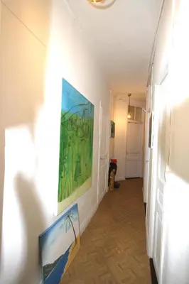 a hallway with a painting on the wall at APPARTEMENT NICE le PORT in Nice