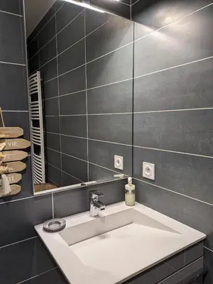 a bathroom with a white sink and a mirror at Studio calme avec vue dégagée in Nice