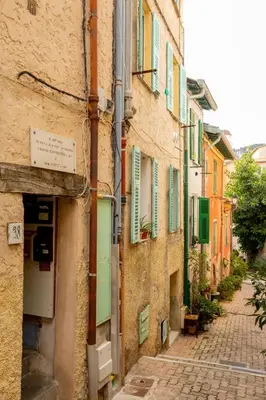 an alley in an old town with colorful buildings at Cozy studio in Villefranche-sur-Mer in Villefranche-sur-Mer
