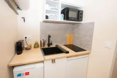 a small kitchen with a sink and a microwave at Cozy studio in Villefranche-sur-Mer in Villefranche-sur-Mer