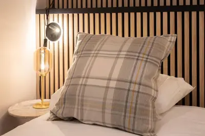 a pillow sitting on top of a bed with a lamp at L37 F1 Central 2 min de la mer Balcon & CLIM in Nice