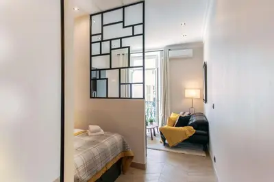 a bedroom with a bed and a mirror at L37 F1 Central 2 min de la mer Balcon & CLIM in Nice