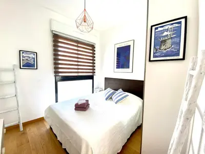 a bedroom with a white bed and a window at Exceptional Terrace in Center of Nice in Nice