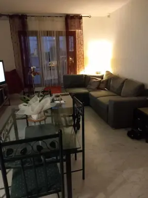 a living room with a couch and a table at Les carlins in Nice