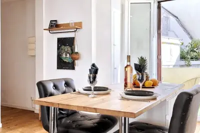a dining room with a wooden table and black chairs at CENTRE VILLE-GRAND APPARTEMENT DE 50 M2 - COSY AVEC TERRASSE -Wifi in Nice
