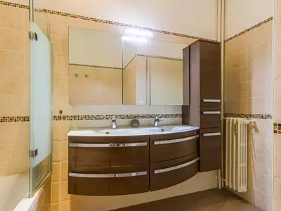 a bathroom with a sink and a mirror at Apartment Le Victor Hugo by Interhome in Nice