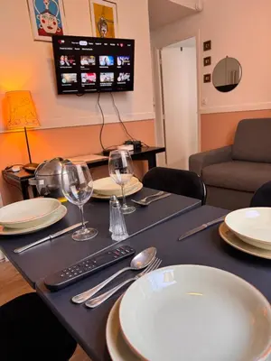 a table with plates and wine glasses on it at Peaceful Flat w WiFi Very Close to Pl Massena Refurbished in Nice