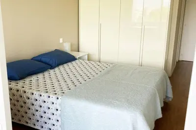 a bedroom with a bed with blue pillows on it at Nice Absea Belles Terres 1 in Nice