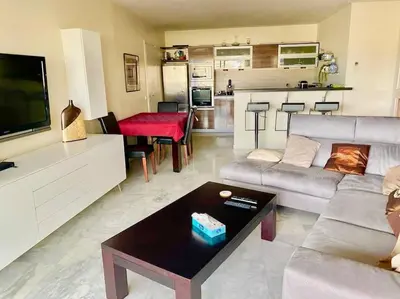 a living room with a couch and a table at Nice Absea Belles Terres 1 in Nice