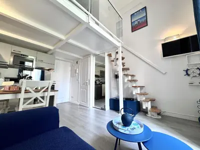 a living room with a blue couch and a window at NICE - Duplex Carré d'Or - 100m promenade des Anglais in Nice