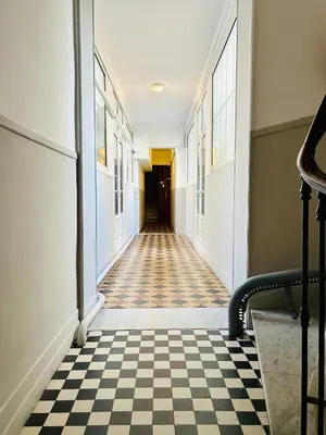 an empty hallway with a checkered floor at Sweet Home 1 ou Sweet Home 2 Réservez Sweet Home 1 ou Sweet Home 2 ou bien les deux in Nice
