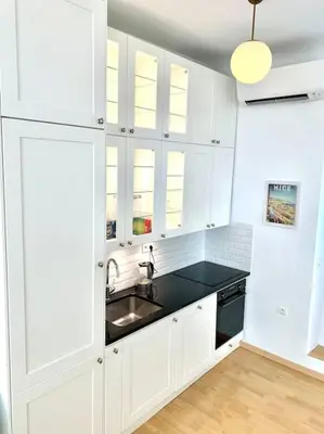 a kitchen with white cabinets and a sink at Saint Philippe - T3 près de la plage in Nice