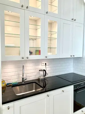 a kitchen counter with a sink and white cabinets at Saint Philippe - T3 près de la plage in Nice