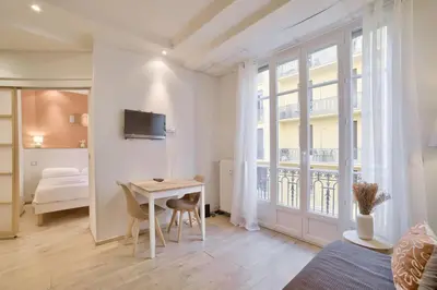 a white room with a desk and a bed and a window at 12 Trachel - T2 lumineux au coeur de Nice in Nice