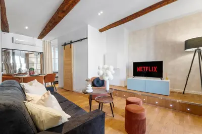 a living room with a couch and a tv at Nice Renting - 9b Massena - Chic Escape in the Heart of Nice Comfort & Charm ! in Nice