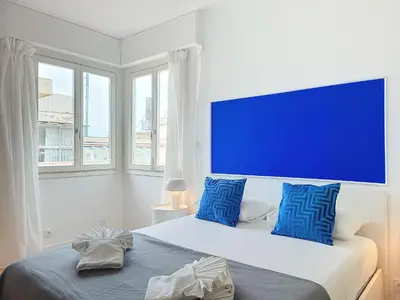 a bedroom with a bed with a large blue headboard at Nestor&Jeeves - LA MAREE BLEUE - TERRACE - NEAR BEACH in Nice