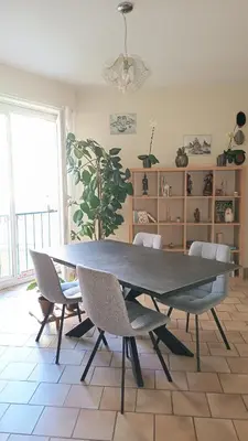 a table and chairs in a room with a plant at Appartement quartier Libération in Nice