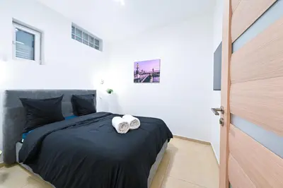 a bedroom with a bed with two towels on it at Grand loft à deux pas de la mer n1 in Nice