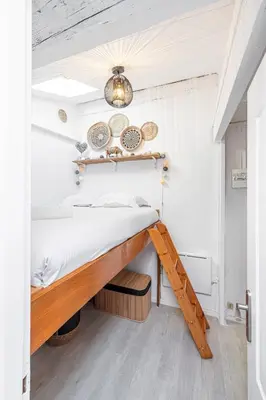 a bedroom with a bed with a wooden frame at Quiet 1 Bdr at Nice Port in Nice