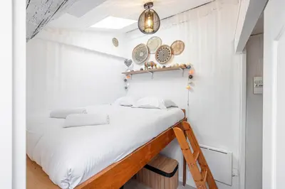 a bed in a small room with white walls at Quiet 1 Bdr at Nice Port in Nice