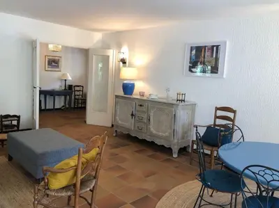 a living room with a table and chairs at Villa de Charme au coeur du Cap-Ferrat in Saint-Jean-Cap-Ferrat