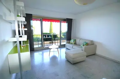 a living room with a couch and a chair at SIRIUS - Exceptionnelle vue mer dans les hauteurs de Nice in Nice
