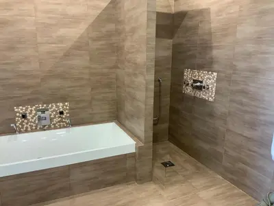 a bathroom with a bath tub and a shower stall at Maison charmante à Aspremont avec piscine privative in Aspremont