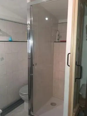 a bathroom with a shower and a toilet at Au lit, on dort in Cantaron