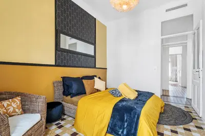 a bedroom with a bed and a couch at Nice Renting - FOCH - Luxury Bourgeois & Design at the Heart of Nice in Nice