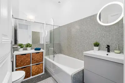 a bathroom with a tub and a toilet and a sink at Nice Renting - FOCH - Luxury Bourgeois & Design at the Heart of Nice in Nice