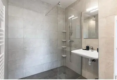 a bathroom with a shower with a sink and a mirror at Nice Absea Belles Terres in Nice