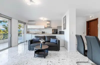 a living room with a couch and a table at Nice Absea Belles Terres in Nice