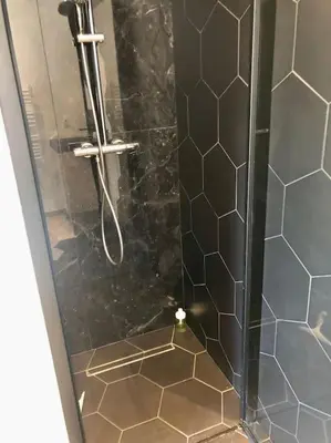 a shower stall with a glass door with a shower at AmorePP Studio design près Stade Allianz Riviera in Nice