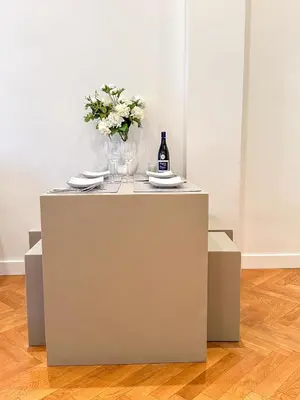 a table with a bottle of wine and a vase of flowers at Les Terrasses D'Herold in Nice