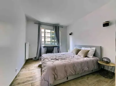 a bedroom with a large bed and a window at 1 min to beach bedroom flat with 2 AC and parking in summer in Nice
