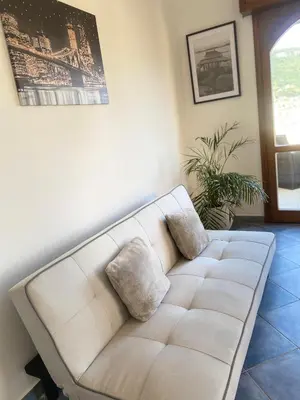 a white couch with two pillows in a living room at APPARTEMENT-NICE 01 VUE MER - PANORAMIQUE WIFI-Parking in Nice