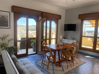 a living room with a table and a couch at APPARTEMENT-NICE 01 VUE MER - PANORAMIQUE WIFI-Parking in Nice