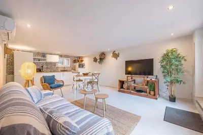 a living room with a couch and a table at Charmant 2 pièces au cœur de St Jean Cap Ferrat in Saint-Jean-Cap-Ferrat